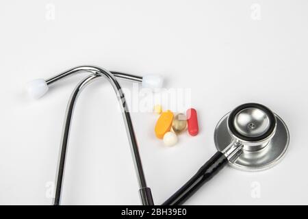 A picture of stethoscope, medicines and clock. It is for medical reminder. Stock Photo
