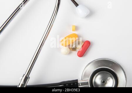 A picture of stethoscope, medicines and clock. It is for medical reminder. Stock Photo
