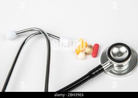 A picture of stethoscope, medicines and clock. It is for medical reminder. Stock Photo