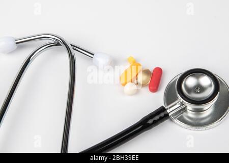A picture of stethoscope, medicines and clock. It is for medical reminder. Stock Photo