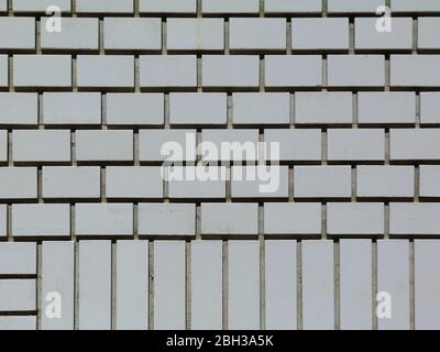 White brick wall elevation detail. deep mortar joints and shadows. running bond and part header course. brick pattern concept. brick wall texture. Stock Photo