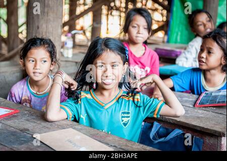 Cambodian school children smile for the camera in a school in the Kampong Phluk (floating) village, Siem Reap Province, Cambodia. Stock Photo