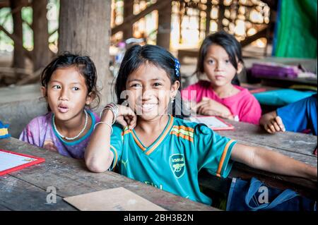 Cambodian school children smile for the camera in a school in the Kampong Phluk (floating) village, Siem Reap Province, Cambodia. Stock Photo