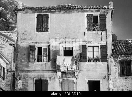 Black and white image of old house with washing hanging from balcony,  Kotor Old Town, UNESCO World Heritage Site, Montenegro, Europe Stock Photo