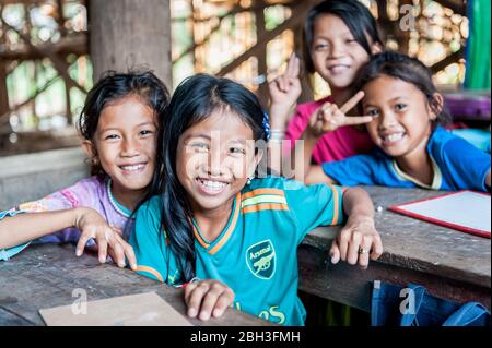 Cambodian school children smile for the camera in a school in the Kampong Phluk (floating) village, Siem Reap Province, Cambodia. Stock Photo