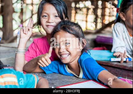 Cambodian school children smile for the camera in a school in the Kampong Phluk (floating) village, Siem Reap Province, Cambodia. Stock Photo