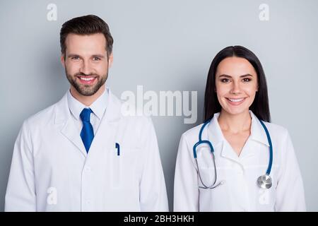 Photo of handsome doc guy practitioner professional pretty lady two people patients consultation virology clinic listen client complaining wear lab Stock Photo