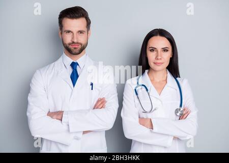 Photo of handsome doc guy professional lady patients consultation virology clinic listen client complaining arms crossed confident doctors wear lab Stock Photo