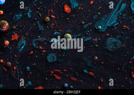 Amazing multi colored bubbles of paint on the oil surface. Stock Photo