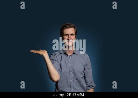 Man Holding Up Hand Open Palm Upwards and Smiling Stock Photo