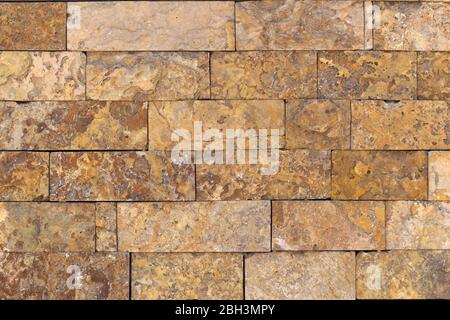 Rust-colored sandstone wall. Natural, rustic style construction. Stock Photo