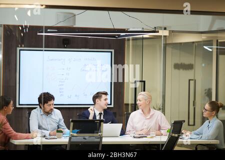 Group of business people sitting at the table and discussing business plans together during business presentation at office Stock Photo