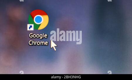 Ukraine, Kiev - April 23, 2020. Close-up of the icon of the Google Chrome browser application on the desktop of a computer screen. The mouse cursor is Stock Photo
