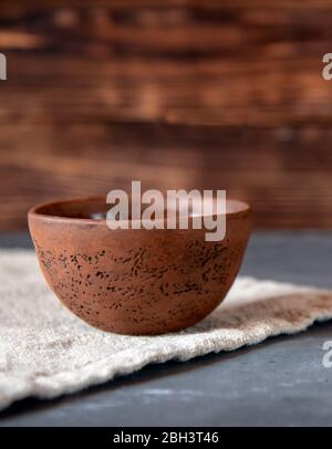 Ceramic bowl with fragrant tea on a linen towel.  Stock Photo