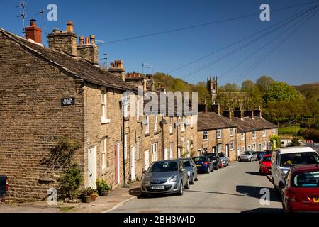 UK, England, Cheshire, Bollington, Lord Street, houses on steep hill with redundant St John the Baptist’s Church in distance Stock Photo