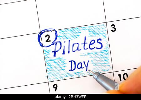 Reminder Pilates Day in calendar with pen. Close up Stock Photo