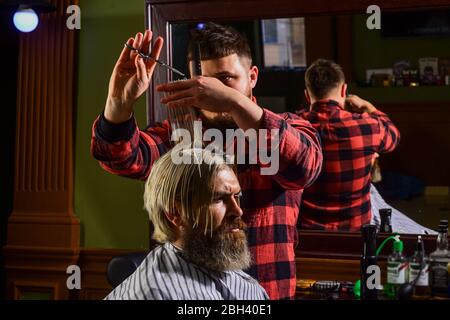 Professional cosmetics. Annoy barber could turn out poorly for your ear. Donation and charity concept. Guy with dyed hair. Cut hair. Barber hairstyle barbershop. Hipster getting haircut. Healthy hair. Stock Photo