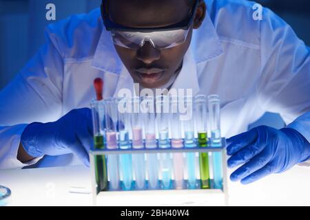Close-up of African scientist examining the samples in test tubes while working at hospital Stock Photo