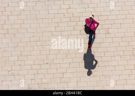 Wien, Vienna: woman walking alone, long shadow, in , Wien, Austria Stock Photo