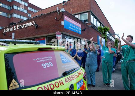 London, UK, 23 April 2020: medical and support staff gathered at the A&E ambulance bay at St George's Hospital, Tooting, to join Clap For Our Carers. Anna Watson/Alamy Live News Stock Photo