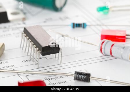 Macro of different electronic parts or components on pcb wiring diagram background with resistors, capacitors, diode and ic chips, selective focus Stock Photo