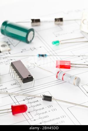 Macro of different electronic parts or components on pcb wiring diagram background with resistors, capacitors, diode and ic chips, selective focus Stock Photo