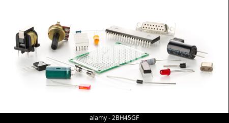 Different electronic parts or components on white background with resistors, capacitors, diode and ic chips, selective focus Stock Photo