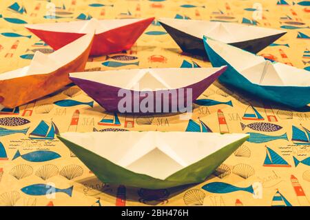 Colorful water color painted paper boats on cartoon background symmetrically arranged Stock Photo
