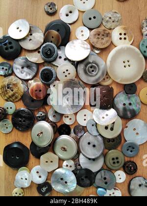 Variety of clothing buttons closeup on table surface Stock Photo