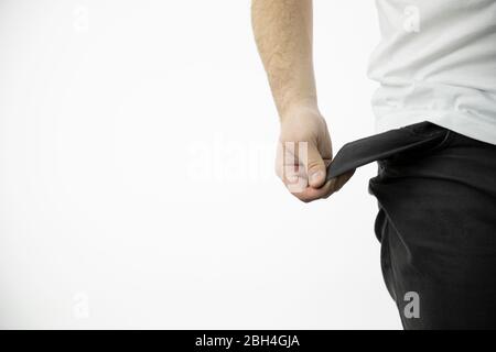 man's hand shows an empty inside-out black pants pocket Stock Photo