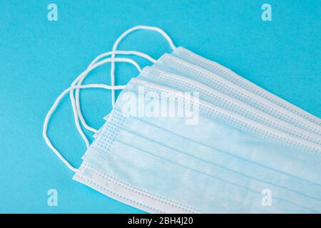 Face medical mask on blue background, top view Stock Photo