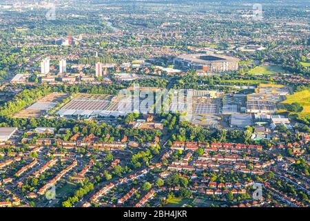 Aerial high angle view from airplane over city of London in United Kingdom with water treatment plant and stadium in summer