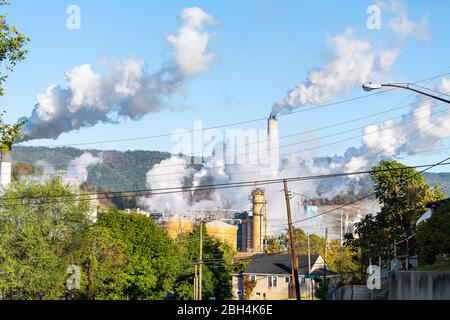 Covington, Virginia city in Alleghany county small town and smog pollution from paper mill smokestack during autumn day Stock Photo