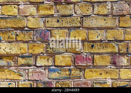 Brick wall design front center abstract closeup with golden gold yellow color and pattern in London, UK Stock Photo