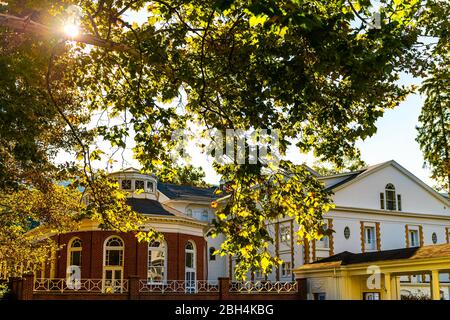 Hot Springs, USA historic downtown town in village city in Virginia countryside with old building architecture and sunlight through branch leaves Stock Photo