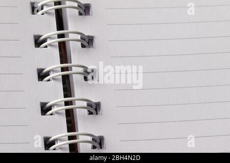 Close up School book page. White empty paper spiral notebook Stock Photo
