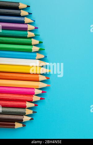 portrait of set of colorful pencils on blue background with copy space Stock Photo