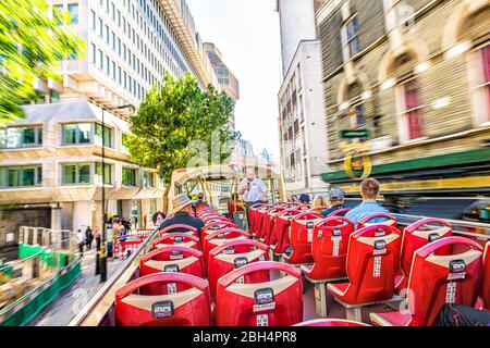 London, UK - June 22, 2018: Red double decker Big Bus with guided tour guide and people tourists driving blurred motion abstract view through street Stock Photo