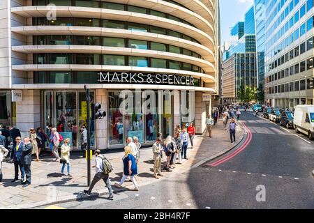 London, UK - June 22, 2018: Marks & Spencer store shop with people walking on sidewalk with large sign exterior entrance on Fenchurch street Stock Photo