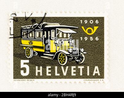 SEATTLE WASHINGTON - April 18, 2020: 1956 Swiss stamp commemorating 50th anniversary of Postal Bus service, featuring first bus of 1906 and posthorn Stock Photo