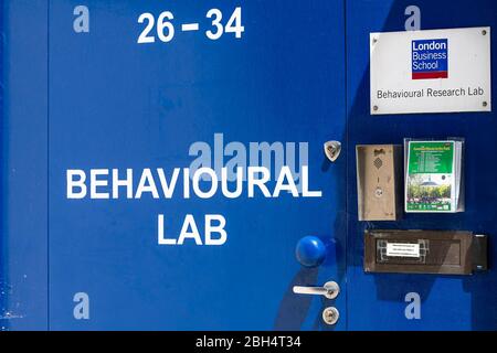 London, UK - June 24, 2018: Street road and University London Business School blue sign closeup and entrance to college Behavioural lab Stock Photo