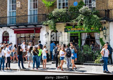 London, UK - June 24, 2018: Downtown during sunny summer day in Marylebone and long line queue crowd by Sherlock Holmes museum Stock Photo