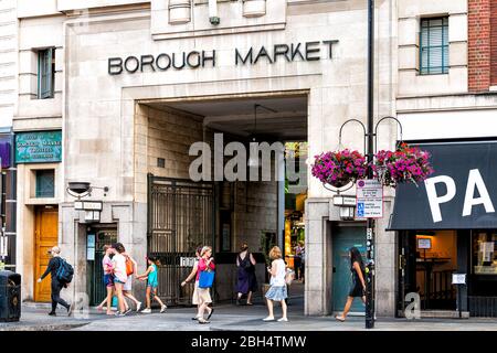 London, UK - June 26, 2018: Downtown during sunny summer day in Southwark near London Bridge and sign for Borough Market entrance and people Stock Photo