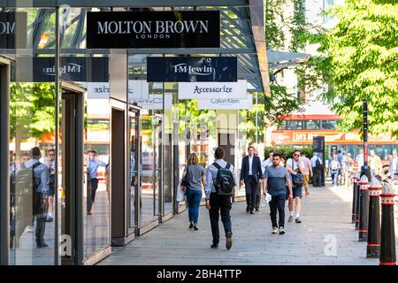 London, UK - June 26, 2018: People pedestrians walking on sidewalk street Cheapside road in center of downtown city by stores for Molton Brown and TM Stock Photo