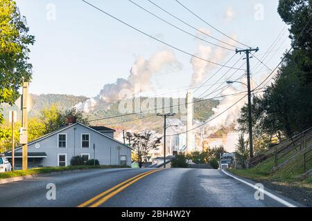 Covington, USA - October 18, 2019: Virginia city in Alleghany county with street road in small town and pollution from WestRock paper mill smokestacks Stock Photo