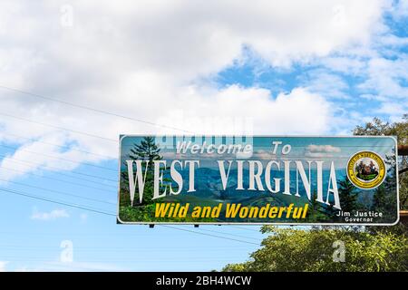 Kenova, USA - October 17, 2019: Welcome to West Virginia sign Wild and Wonderful with mountains picture and blue sky by Kentucky border Stock Photo