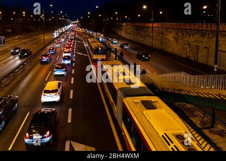 Warsaw, Poland - December 20, 2019: Above high angle aerial view of Aleja Armii Ludowej street avenue in Warszawa at night with traffic cars, people s Stock Photo