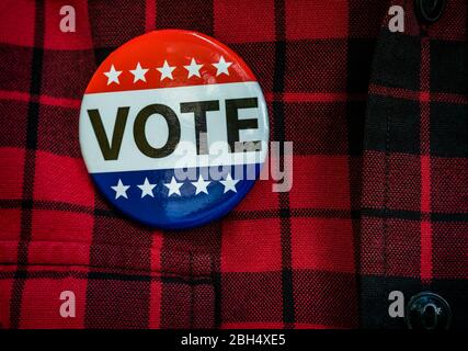 Vote button on red checked shirt Stock Photo
