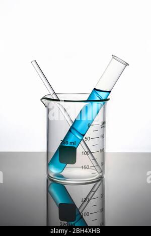 Blue liquid in test tube inside beaker Stock Photo