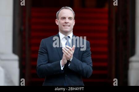 Foreign Secretary Dominic Raab clapping outside the Foreign and Commonwealth Office in London to salute local heroes during Thursday's nationwide Clap for Carers initiative to recognise and support NHS workers and carers fighting the coronavirus pandemic. PA Photo. Picture date: Thursday April 23, 2020. See PA story HEALTH Coronavirus. Photo credit should read: Frank Augstein/PA Wire Stock Photo